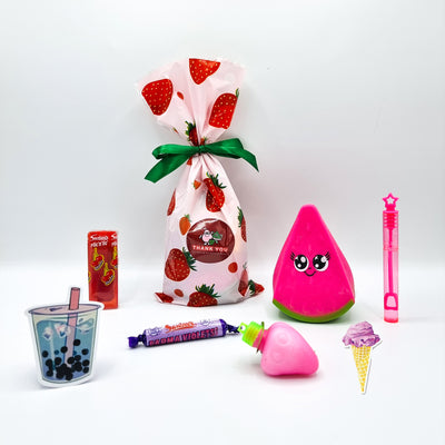 Pre filled pink strawberry fruit birthday party goody bags for girls with toys and sweets, party favours. 