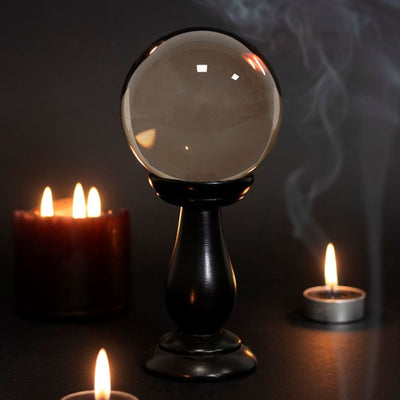 Small Smoke Grey Crystal Ball Ornament On Wooden Stand.